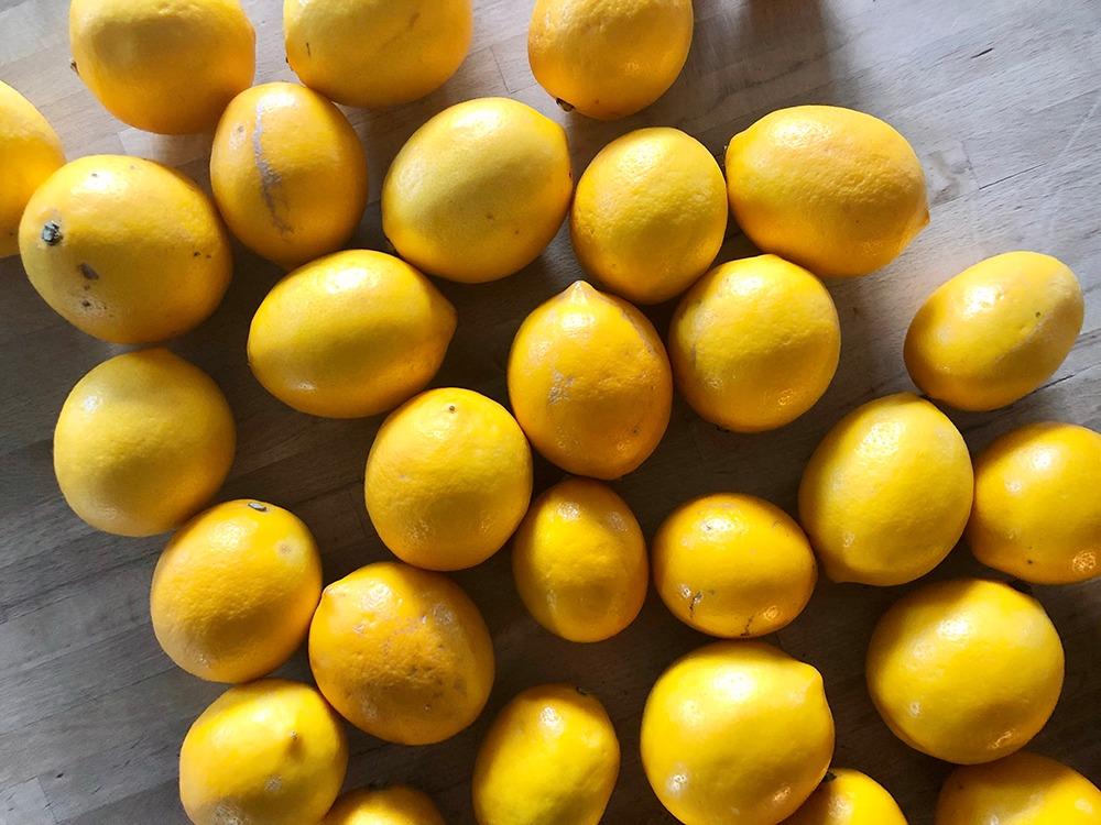 whole meyer lemonds on wooden table